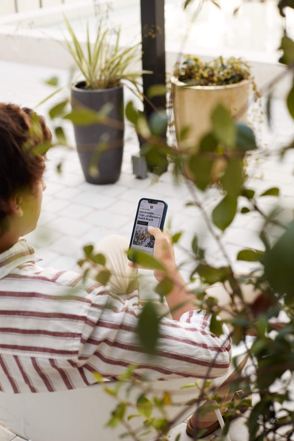 Guy seated looking his mobile phone